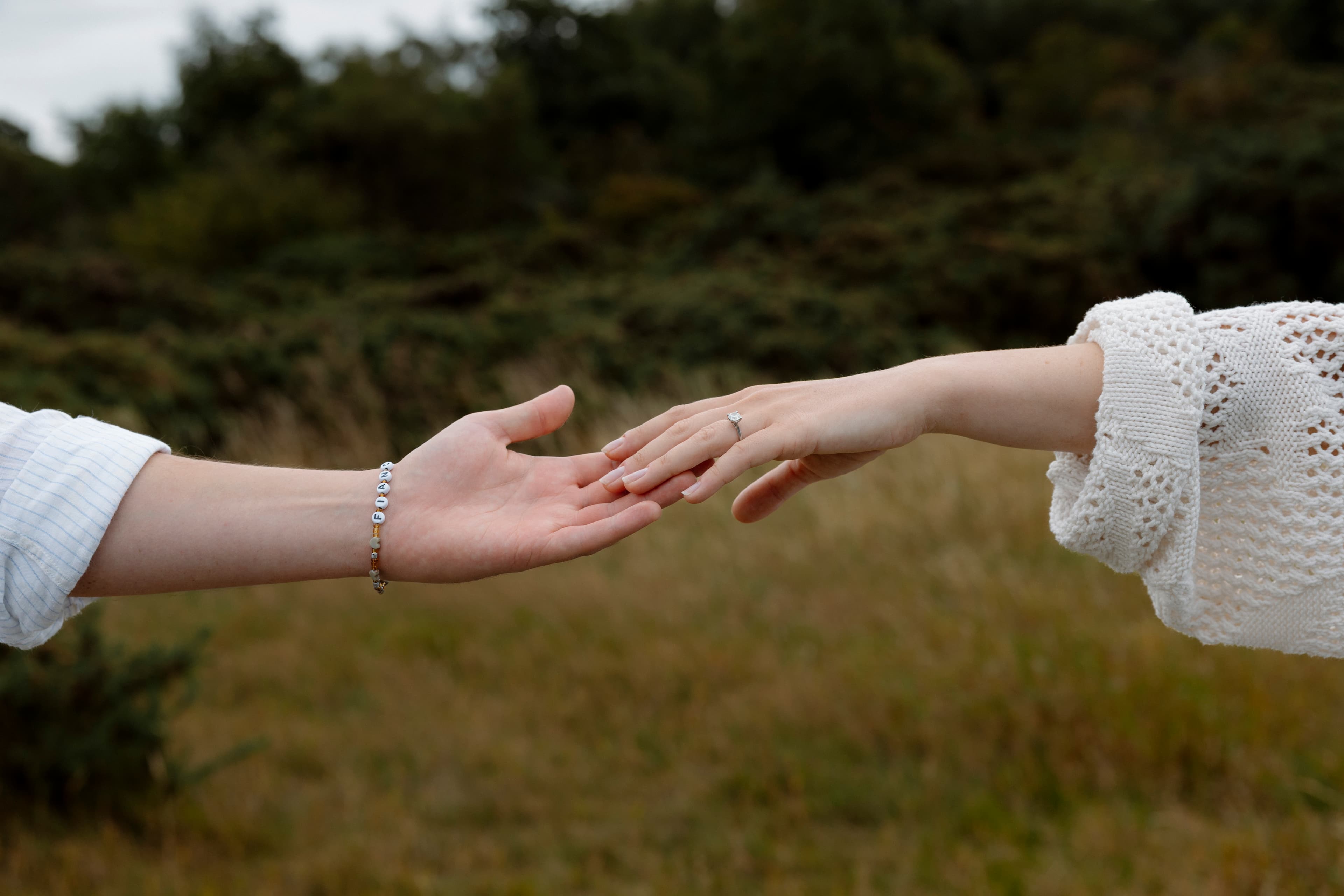 Daniel and Marta reaching for each other's hands